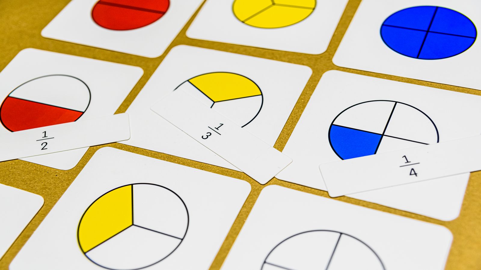 Fraction being reduced to simplest form with factor trees drawn on paper